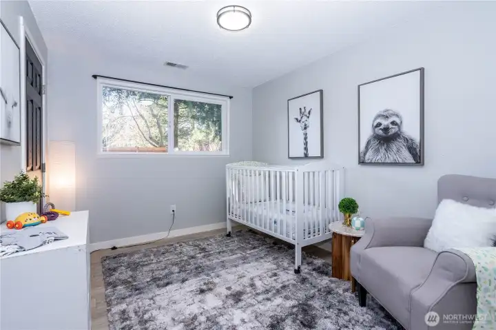 Currently staged as a nursery, this bedroom highlights the home’s versatility and family-friendly layout. Soft natural light enters through the window, keeping the room bright while still comfortable for rest. The plush carpeting adds warmth underfoot, distinguishing it from the main living areas and making it especially suitable for a child’s room. There’s ample wall space for a crib, seating and storage, allowing the room to evolve easily over time — from nursery to toddler room to full bedroom. Neutral finishes ensure it can transition with changing needs, while the overall size keeps it practical without feeling oversized. It’s a flexible space designed to grow alongside its occupants.