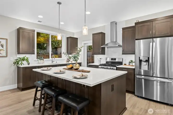 210 power was installed behind the gas range making it an easy swap if induction cooking is preferred.  The oversized window above the sink with the sun filtering through the trees and the magical gardens will make you look forward to clean up :)