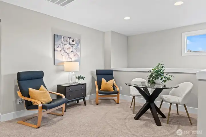 Bright, open loft at the top of the stairs is great for a study area or just another cozy relaxation space