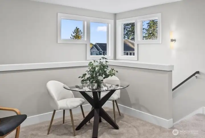 The corner windows bring abundant light in throughout the day, and in the evenings you can see the glow over the partial view of Mt. Rainier.  An often overlooked feature is the overall elevation of The Heritage.  Rather than nestled down in the woods, it is perched above the surrounding area maximizing the natural light at all hours of the day.