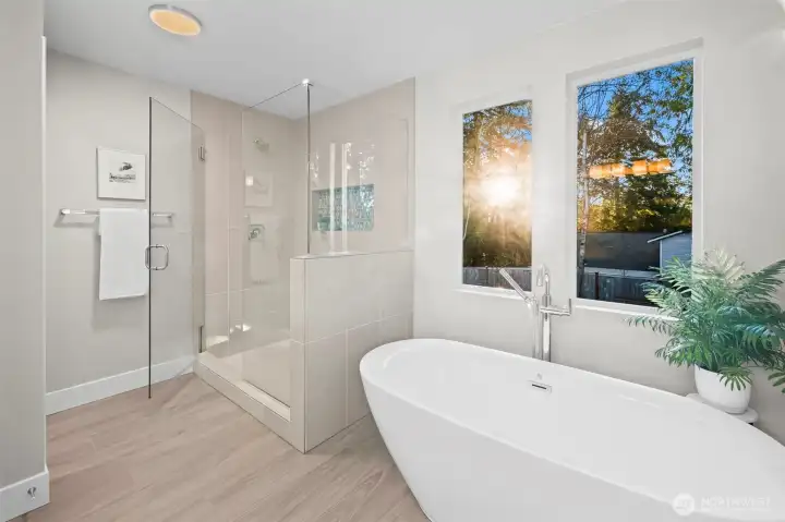Together with a beautiful walk in shower that has NEVER been used and a free standing soaking tub beneath the picture windows framing the sunset