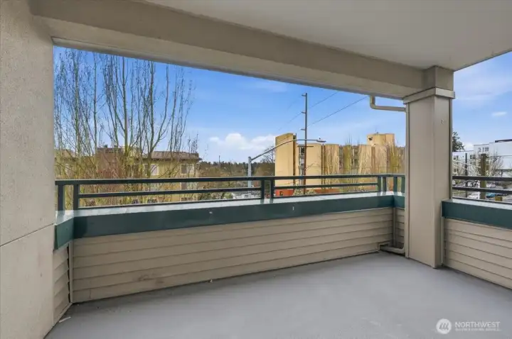 Corner balcony overlooks the not-too busy street