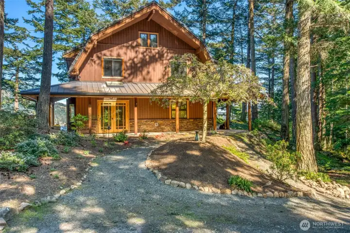 The west side of the home is filled with sunlight surrounded by native landscaping, with a few selective species to complement the nature. Wrap around deck welcomes you home. This 3 bedroom/3bath home, designed with an open floor plan, sits at the top of the bank overlooking East Sound and sits nestled into the mossy knolls surrounded by lush forest and wildlife.