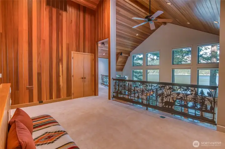 Upper loft area overlooks the lower floor below and enjoys big views through large floor to ceiling windows.