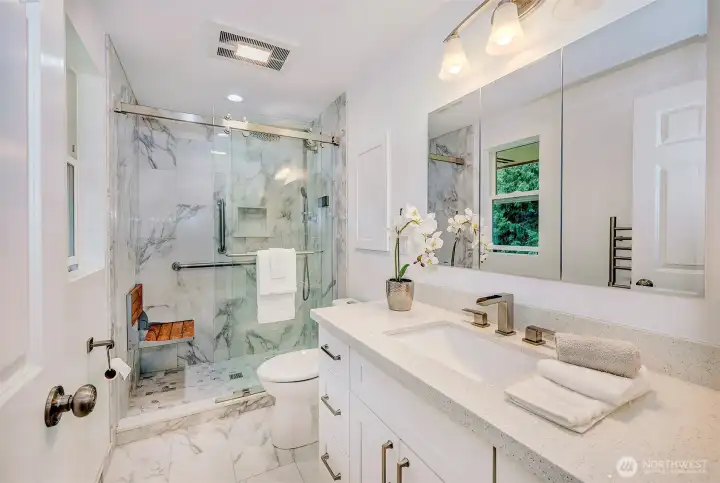 Updated Primary ensuite Bathroom with Temp control faucet and towel warmer.