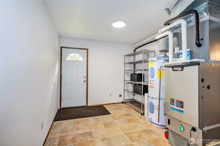 Spacious utility room off of attached garage, and next to flex space