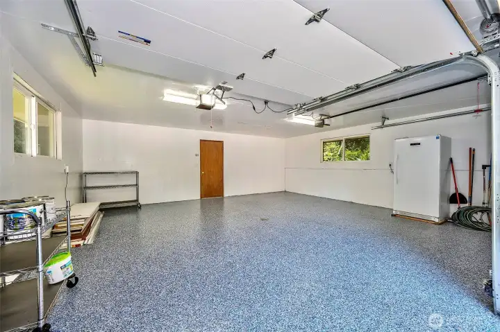 Attached 2 car garage with finished epoxy floor.