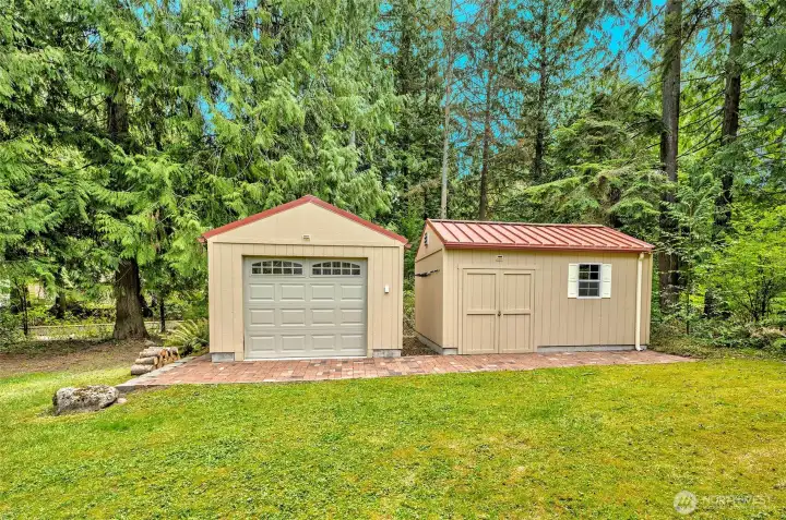 Storage sheds w/ metal roof, epoxy floor, Heat, fan, lights, outlets, one has an auto Garage door, Gladiator cabinet.