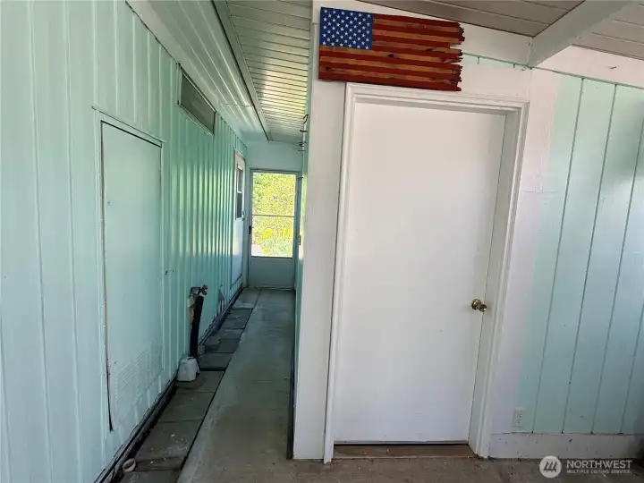 Storage shed in the back of the carport, and a passthrough to the backyard.
