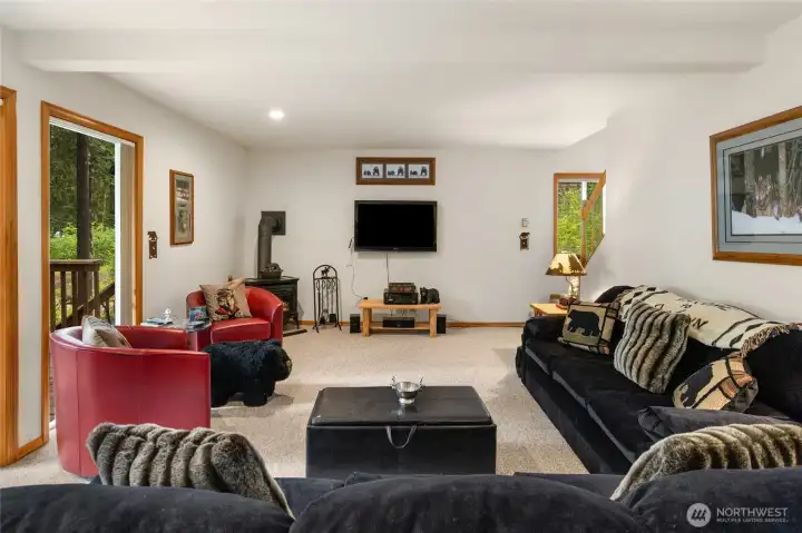 Living room with a cozy gas fireplace. The carpet is a heavy duty Berber carpet helps prevents wear and tear.