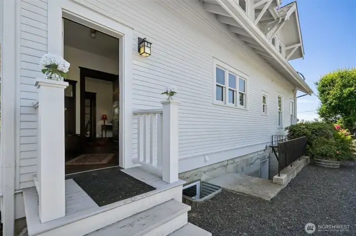 North side of house with exit from mud room and downstairs exit up the stairs to outside.