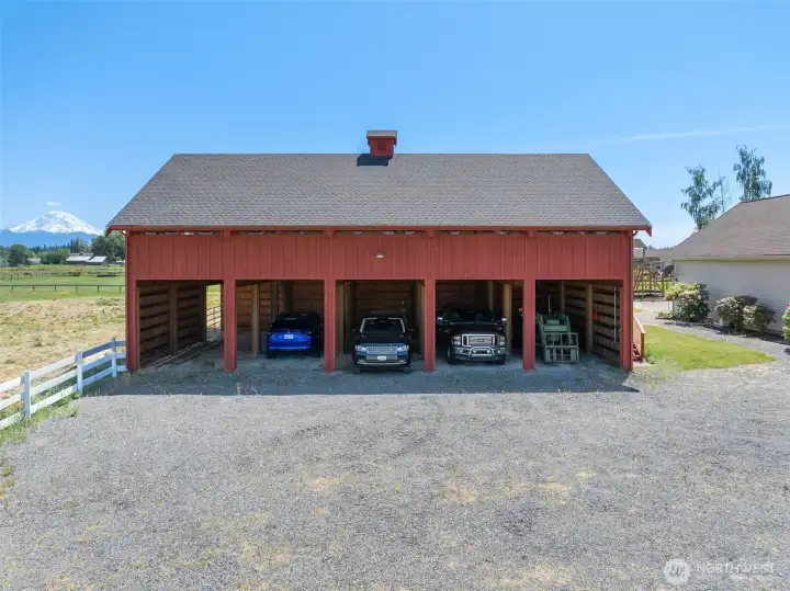 10 spaces for covered parking equipment with huge loft above. Pasture space to the left. Shop to the right with 3,000 sq ft entertainment space.