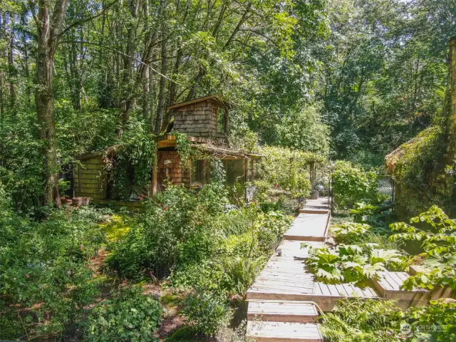 Out building/ green house. Has 3/4 bath and washer /dryer. Main home on right.