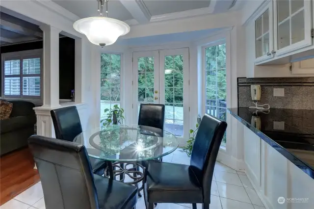 Beamed ceilings, French doors to the deck and more custom millwork, the kitchen dining room is nearly perfect