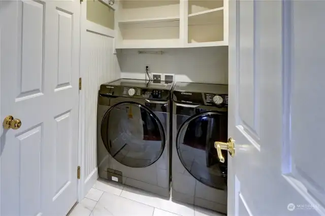 Downstairs laundry room with lots of sheves