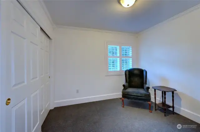 The third bedroom with a double closet and shuttered window