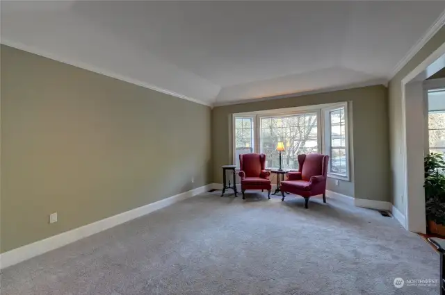 Formal living room with large bay window is just off the entry hall