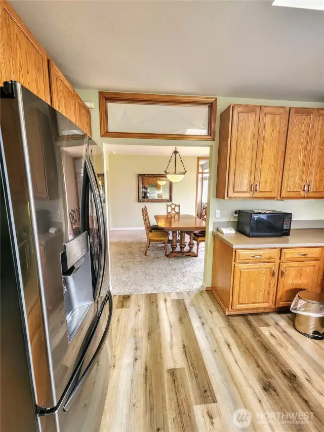 View from kitchen to dining room in 2nd home.  Gorgeous, wide plank LVP flooring.