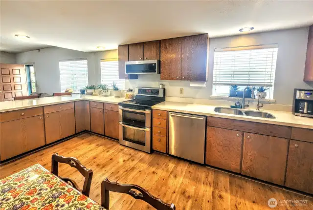 Plenty of quartz counter space with upgraded stainless steel appliances.   Double oven and streamlined microwave oven.