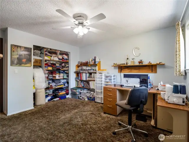 The second bedroom (here used as a craft room) also has a built in desk.