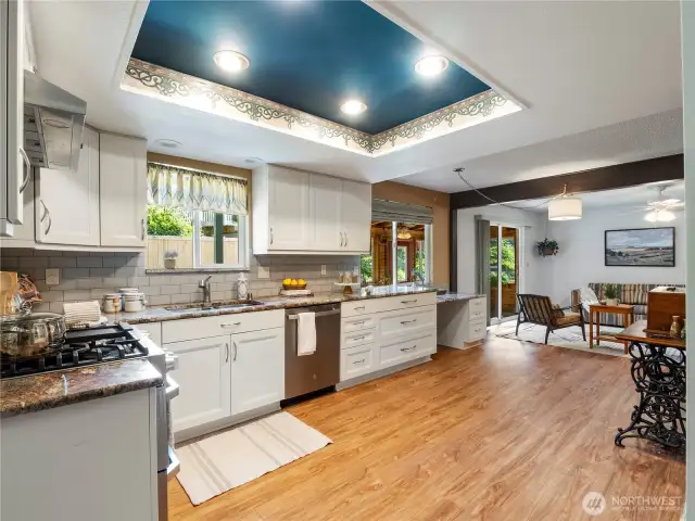 Welcome to this spacious kitchen with its stainless steel appliances and white cabinets.
