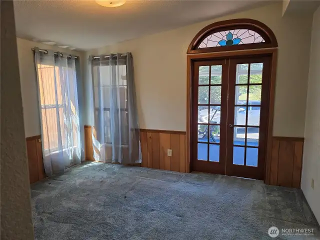 Primary Bedroom which opens out to enjoy the Sunroom through these Beautiful Frenc doors