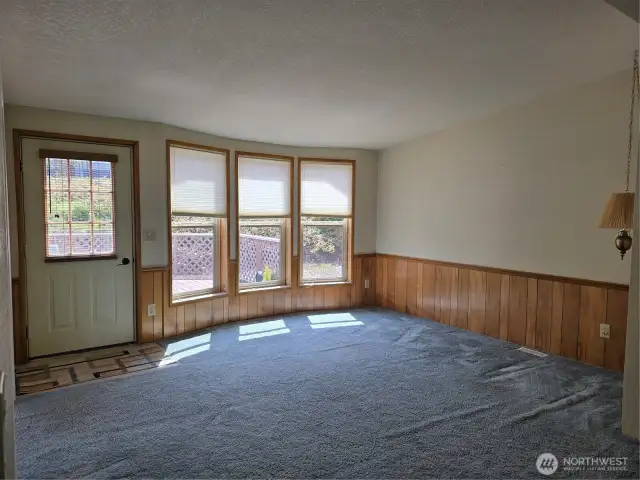 Living room with view of large deck & hillside.