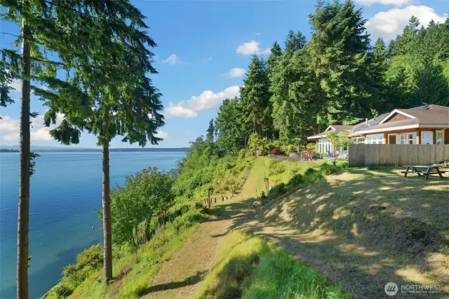 Grand promenade to the water is a hillside garden. Professionally designed in 2006, the switchbacks lead you down to the waterfront on wide, grassy pathways.