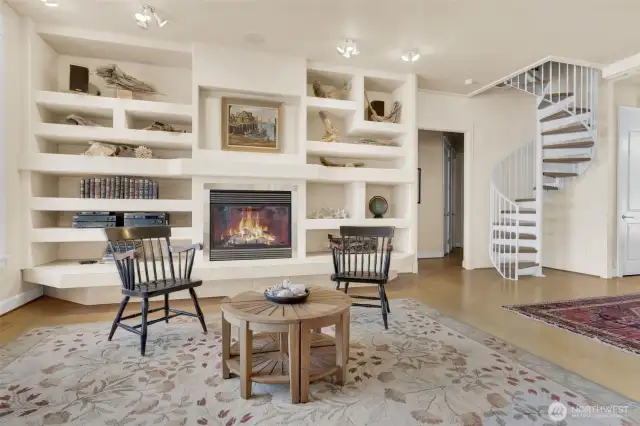 Tiled fireplace hearth, surround to the ceiling with built in display shelving. Wired for home theater with seven speaker surround sound.