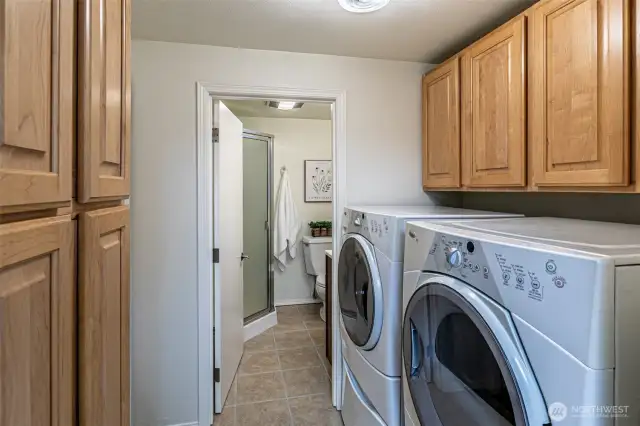 Laundry with storage off the kitchen with 3/4 bath beyond.