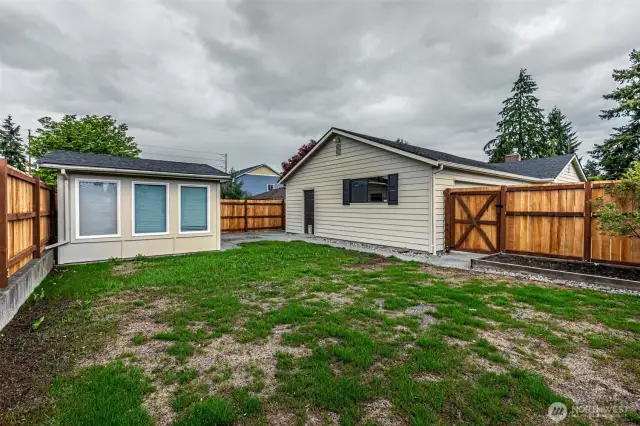 sideyard with nice shed & side of the home with man door.  Nice sidewalk connects connects.