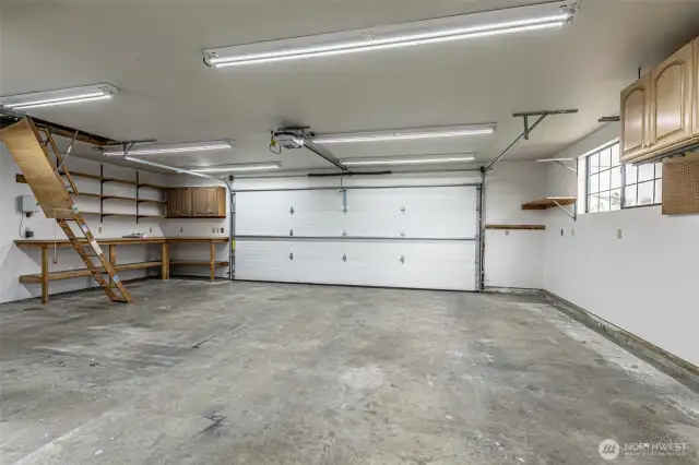 Oversized garage with big storage/workshop area, LED lighting  and pull down stairs to the attic.