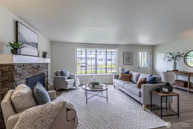 Spacious living area anchored by the gas fireplace, window seat picture window is ready for a custom cushion in your accent color choice.   Interior has just been repainted.