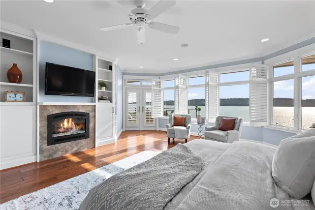 French doors off the primary suite lead to an  amazing deck overlooking the Puget Sound,  perfect for enjoying morning coffee or  evening sunsets.
