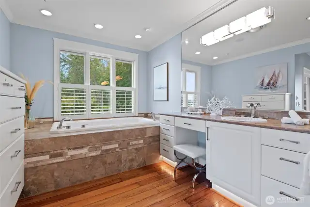 Indulge in the serenity of the primary bath, where a luxurious soaking tub invites you to unwind while taking in peaceful views—an everyday escape designed for relaxation and renewal.