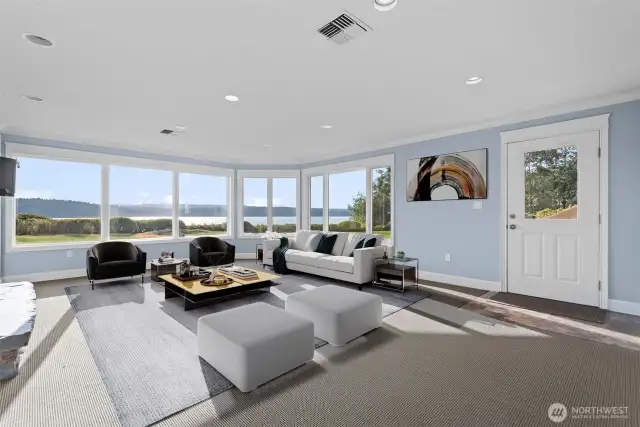 Step into the inviting downstairs bonus room, where comfort meets elegance. A cozy fireplace sets the tone for a warm, welcoming retreat—ideal for relaxing or entertaining year-round, complete with its own private outside entry.