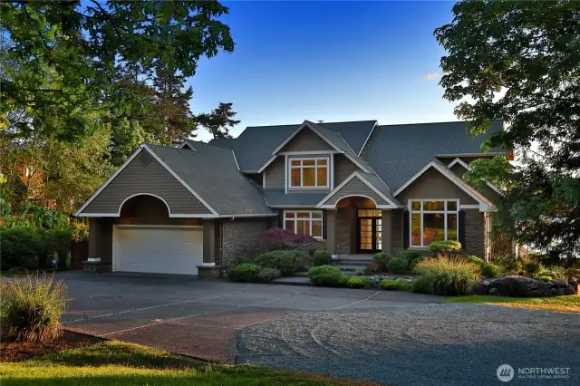 The front facade of the Whidbey Island estate  showcases exceptional architectural design  harmoniously blending with its natural  surroundings.