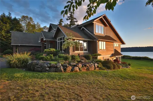 A stunning view of the home and expansive side yard highlights the property's generous scale and thoughtful design—offering ample space for yard games, outdoor entertaining, or simply enjoying the natural surroundings.