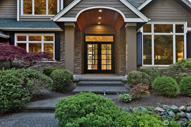 The grand entrance is  highlighted by dramatic gabled rooflines and  expansive windows that invite abundant  natural light.
