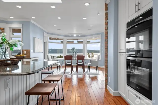 Enjoy effortless flow from the living room to the dining area and kitchen—all united by spectacular views of the Sound. French doors open to the deck, extending the living space and capturing the beauty of the surroundings at every turn.
