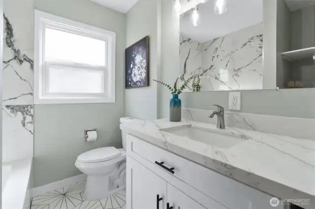Upgraded bath with quartz countertop, new shower and flooring.