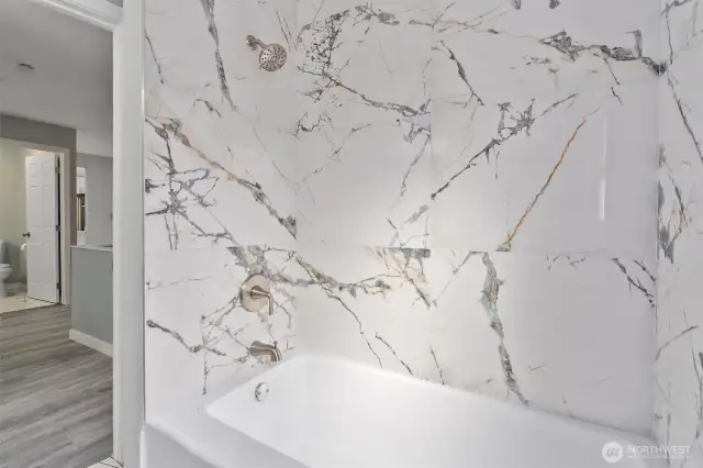 Upgraded bath with quartz countertop, new shower and flooring.