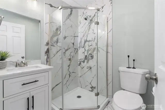 Upgraded bath with quartz countertop, new shower and flooring.