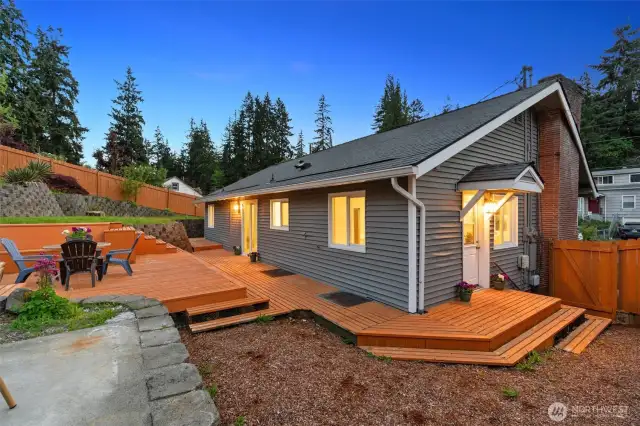 Backyard is nicely scaped and is perfect for entertaining! Large deck and patio. Door from the dining room and door from the kitchen lead to the deck.