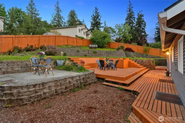 Backyard is nicely scaped and is perfect for entertaining! Large deck and patio. Door from the dining room and door from the kitchen lead to the deck.
