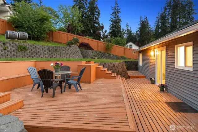 Backyard is nicely scaped and is perfect for entertaining! Large deck and patio. Door from the dining room and door from the kitchen lead to the deck.