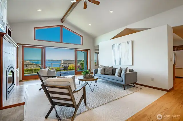 Living room with view, vaulted ceilings, gas FP, and custom built-ins