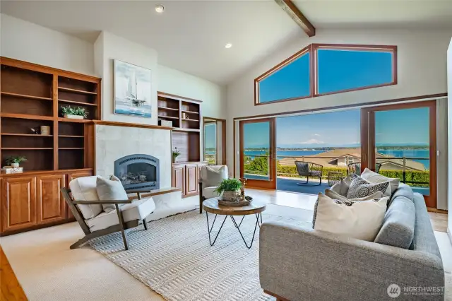 Living room with view, vaulted ceilings, gas FP, and custom built-ins