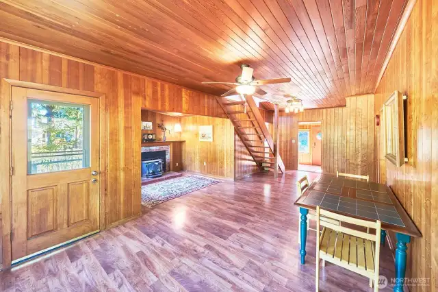 Looking back to entryway, fireplace nook on the left, back door to deck and back yard. Bedrooms on right.