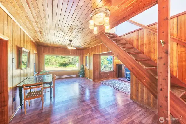 From entry - living room, bedrooms on left, fireplace nook on right. Stairs up to full floor studio/primary bedroom.